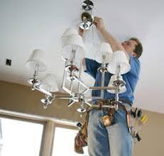 Electrician installing chandeliar